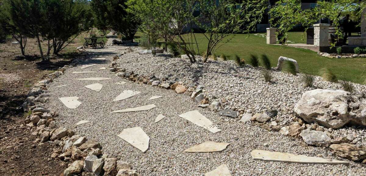 Kay Johnson uses the limestone pathway in the backyard to feed the area deer. She said they follow her around like ducklings.