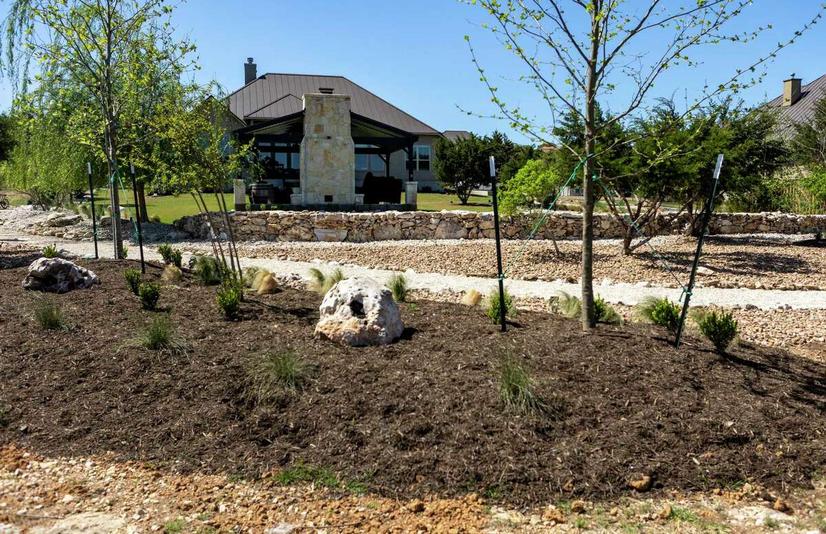 The home’s thin, rocky soil makes planting difficult, so landscaper Cooper Henk built several berms throughout the yard to give the new plantings, especially the trees, room for their roots.