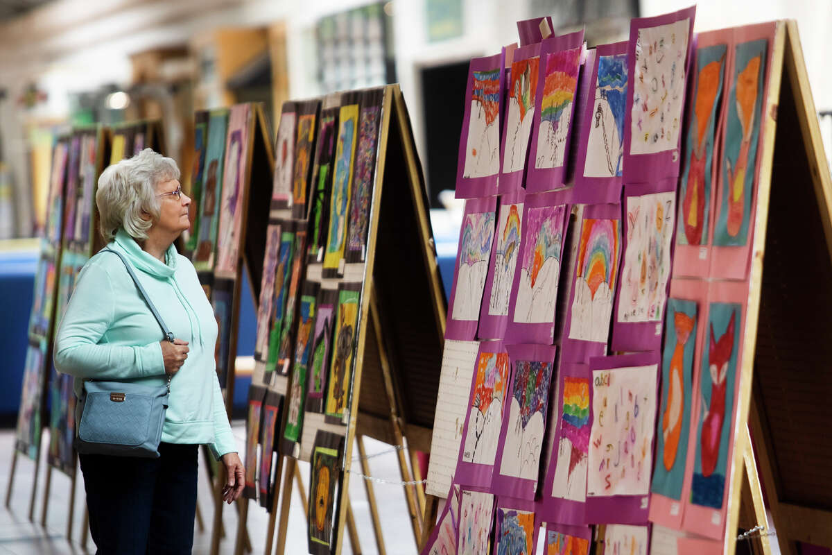 Barb Milkowski of Bay City looks at artwork displayed in the Midland Public Schools Elementary Art Show Tuesday, April 12, 2022 at the Midland Mall.