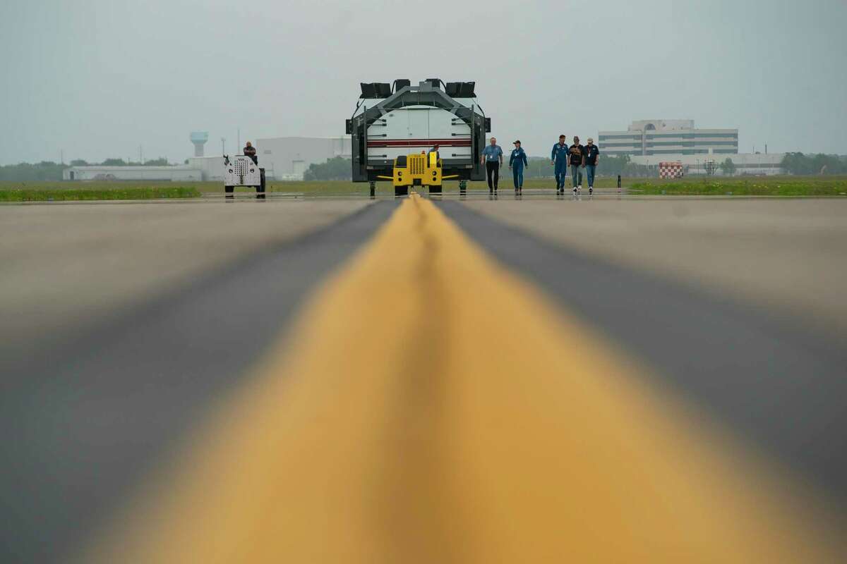 Accompanied by former NASA Astronauts Bonnie J. Dunbar and Mario Runco Jr., the Space Shuttle Motion Base Simulator is slowly moved down a taxiway at Ellington Field to its new home, Tuesday, April 12, 2022, at the Lone Star Flight Museum in Houston. The simulator, a full-scale replica of the forward flight deck of a space shuttle orbiter, was built in 1976 and first used to support flight crew training for the STS-1 mission on Jan. 9, 1979.