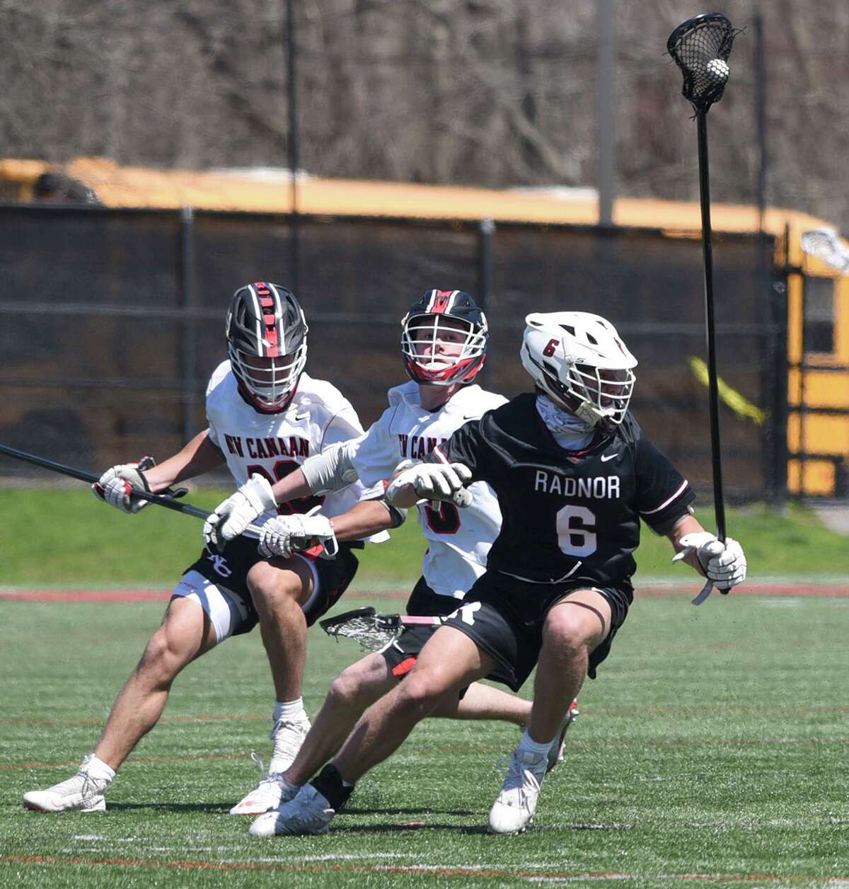 Radnor's Luciano Chadha (6) controls the ball in front of New Canaan's William Hayes (48) and John Totaro (15) during a boys lacrosse game in New Canaan on Tuesday, April 12, 2022.