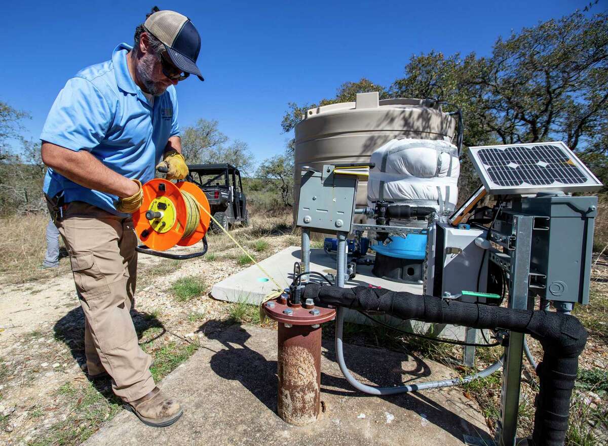 Charles Crawford, data collection supervisor for the Edwards Aquifer Authority, measures the water height on March 30 of a well at the authority’s Field Research Park in far North San Antonio. Once a month, Aquifer Authority employees manually check water levels in its monitor wells throughout the region to confirm the accuracy of data generated every 15 minutes by remote sensors.
