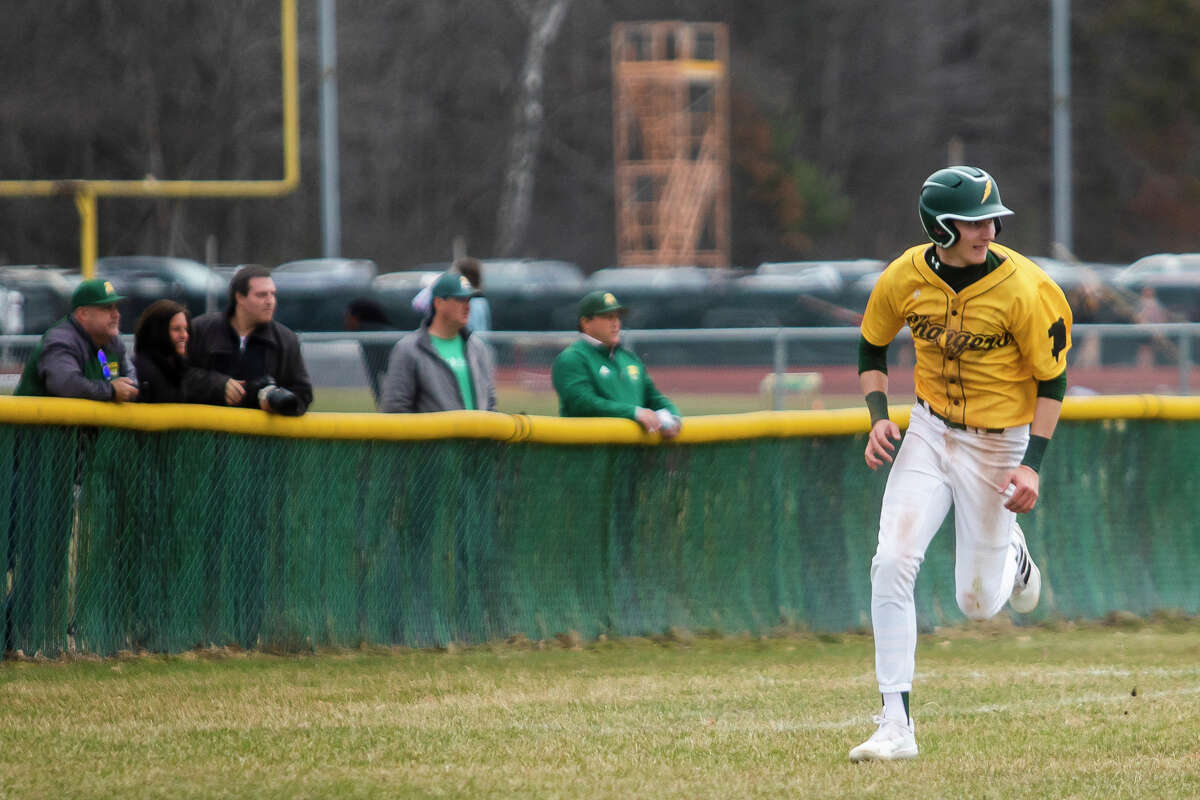 Dow's Joe Craig rounds third base before scoring a run during the Chargers' game against Traverse City West Tuesday, April 12, 2022 at H. H. Dow High School.