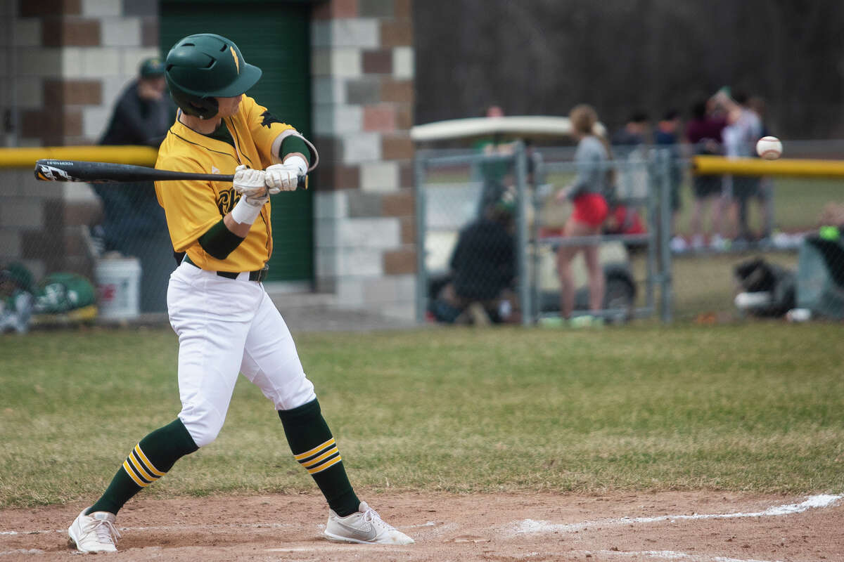 Dow's Nolan Sanders swings on a pitch during the Chargers' game against Traverse City West Tuesday, April 12, 2022 at H. H. Dow High School.