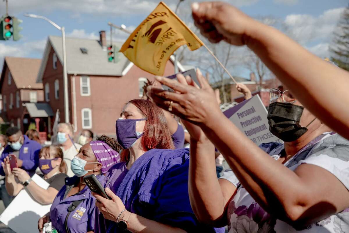 Kara Dwyer, center, and other protestors with health care union SEIU 1100NE, ask police to release detained protestors in Hartford in April 2021. About 100 protestors gathered to ask for better treatment of nursing home, long-term care, home care, group home workers, including health insurance, better wages and proper PPE.