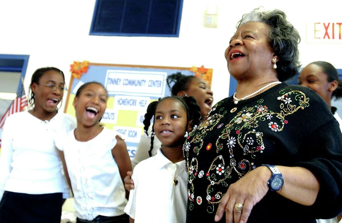 Naomi Wallace and Brittany Washington,7, share a laugh at the end of their singing performance in honor of Martin Luther King, Jr. at the Tinney Community Center in 2003.