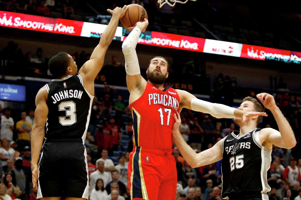 Jonas Valanciunas of the New Orleans Pelicans is blocked by Sprus forward Keldon Johnson in the first quarter at Smoothie King Center on March 26, 2022 in New Orleans, Louisiana.