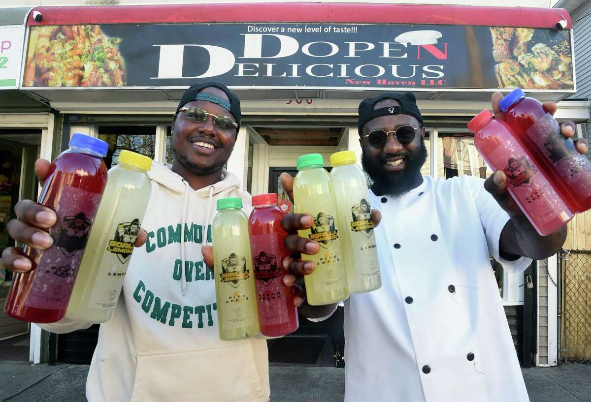 Eat Up owners Kristen Threatt and Brian Burkett-Thompson hold the four varieties of their Gorilla Lemonade outside of Dope N Delicious in New Haven where their products are sold.