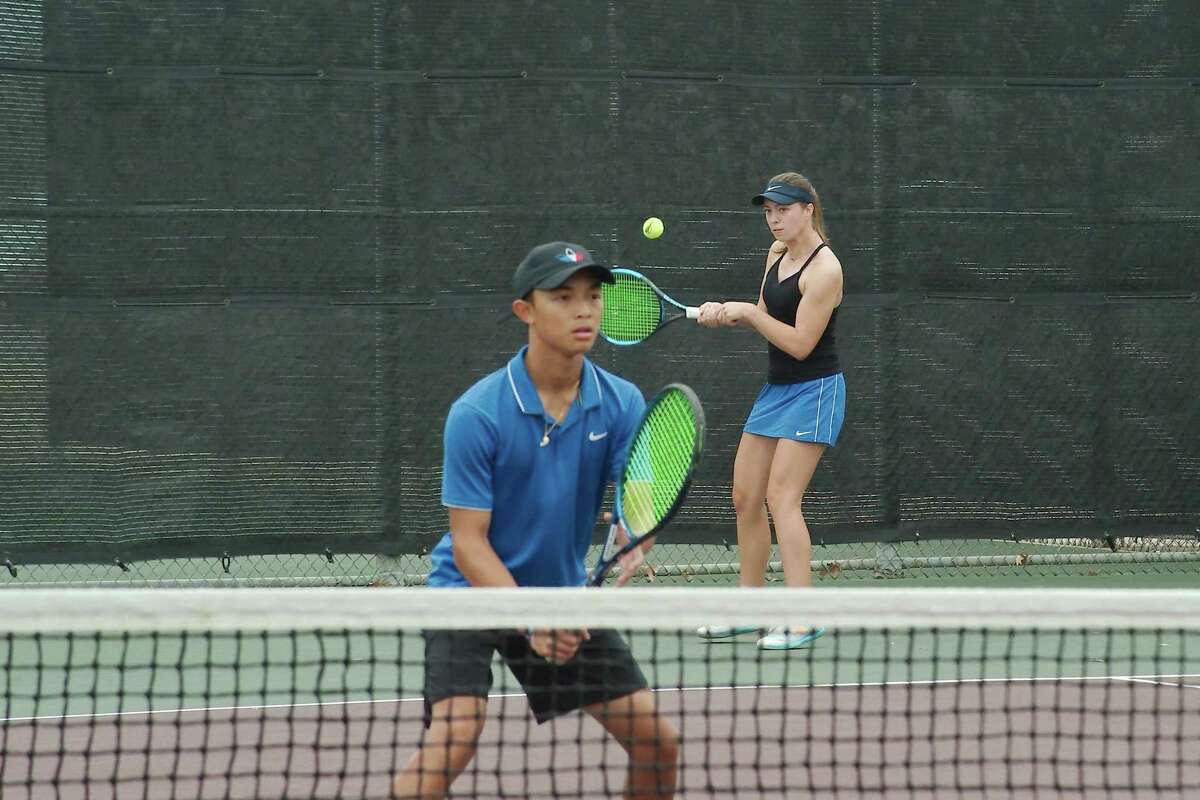 Clear Springs' Heinjte Unson and Zoe Male compete in a mixed doubles match against Lamar Tuesday at the Region 3-6A Tennis Tournament at Deer Park High School.