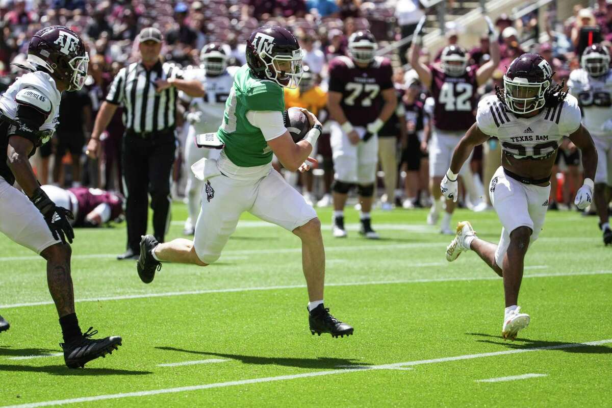 Texas A&M quarterback Haynes King, scoring a touchdown during the spring game, isn’t allowed to talk to the media except for the paid interviews he gives to a fan website.