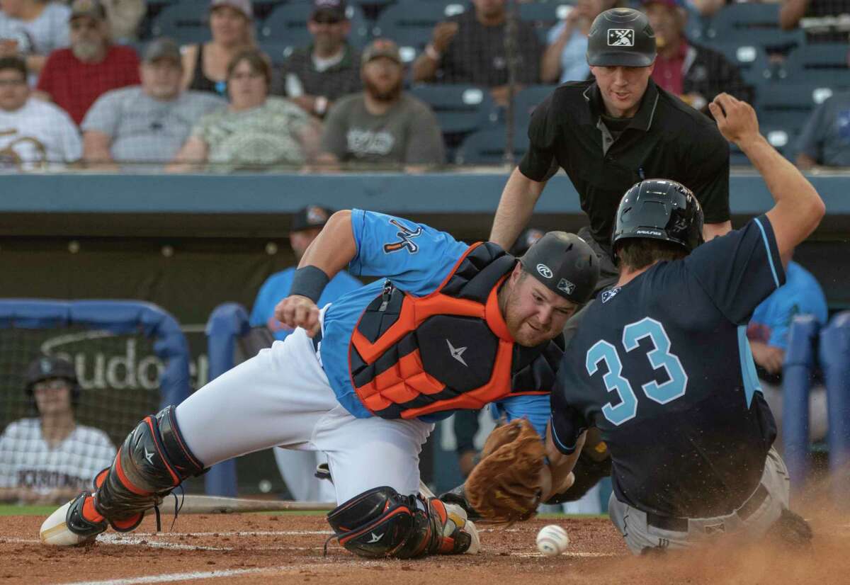 RockHounds' Kyle McCann tries to make the tag on Hooks' Justin Dirden but looses control of the ball 04/12/2022 at Momentum Bank Ballpark. Tim Fischer/Reporter-Telegram