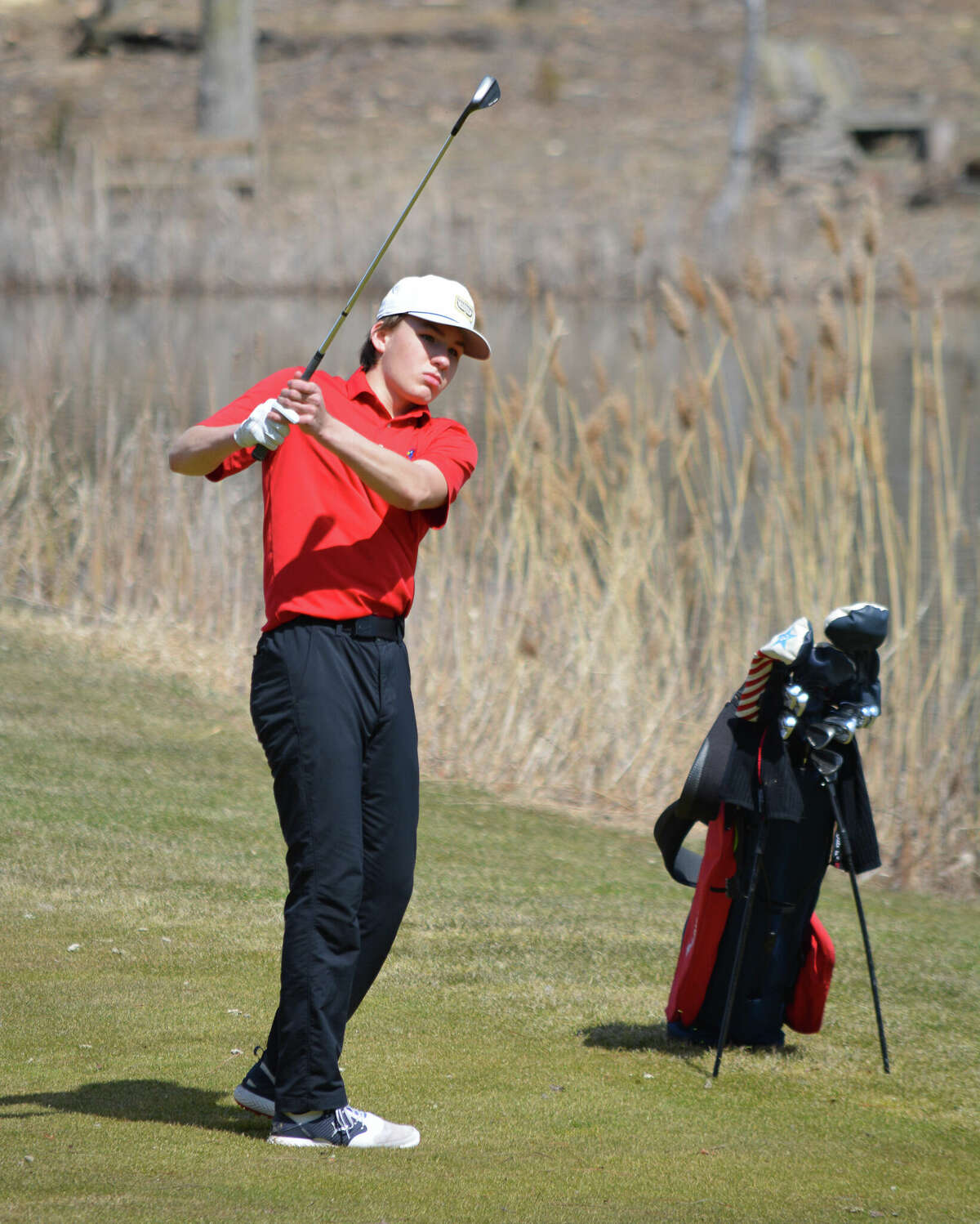 Big Rapids' Luke Welch hits his approach on hole 10.