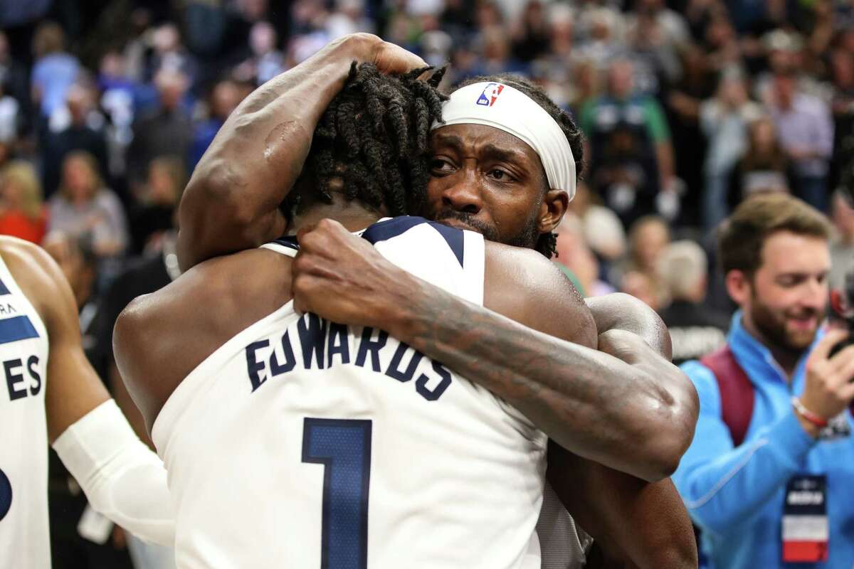 Patrick Beverley #22 and Anthony Edwards #1 of the Minnesota Timberwolves celebrate a 109-104 victory against the Los Angeles Clippers to advance to the NBA Playoffs during a Play-In Tournament game at Target Center on April 12, 2022 in Minneapolis, Minnesota.