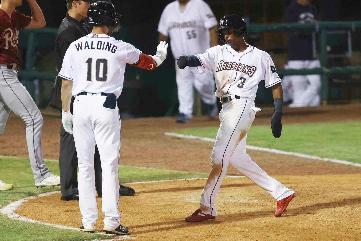 San Antonio Missions' Esteury Ruiz (03) gets a high-five after scoring in the 5th inning during their home opener at Wolff Stadium against the Frisco Roughriders on Tuesday, Apr. 12, 2022.