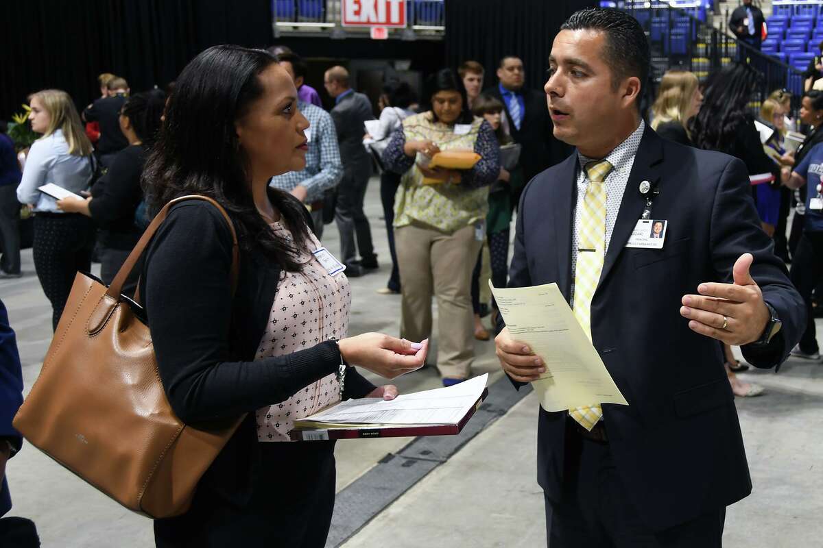 Dr. Abe Lozano, then the principal at Holbrook Elementary School, speaks with a guest at the CFISD Career Fair in April 2019. Now the principal at Watkins Middle School, Lozano will be among numerous district campus and department administrators in attendance at the meet-and-greet fair, to be held April 28 at the Berry Center. The fair returns as an in-person event for the first time since 2019.