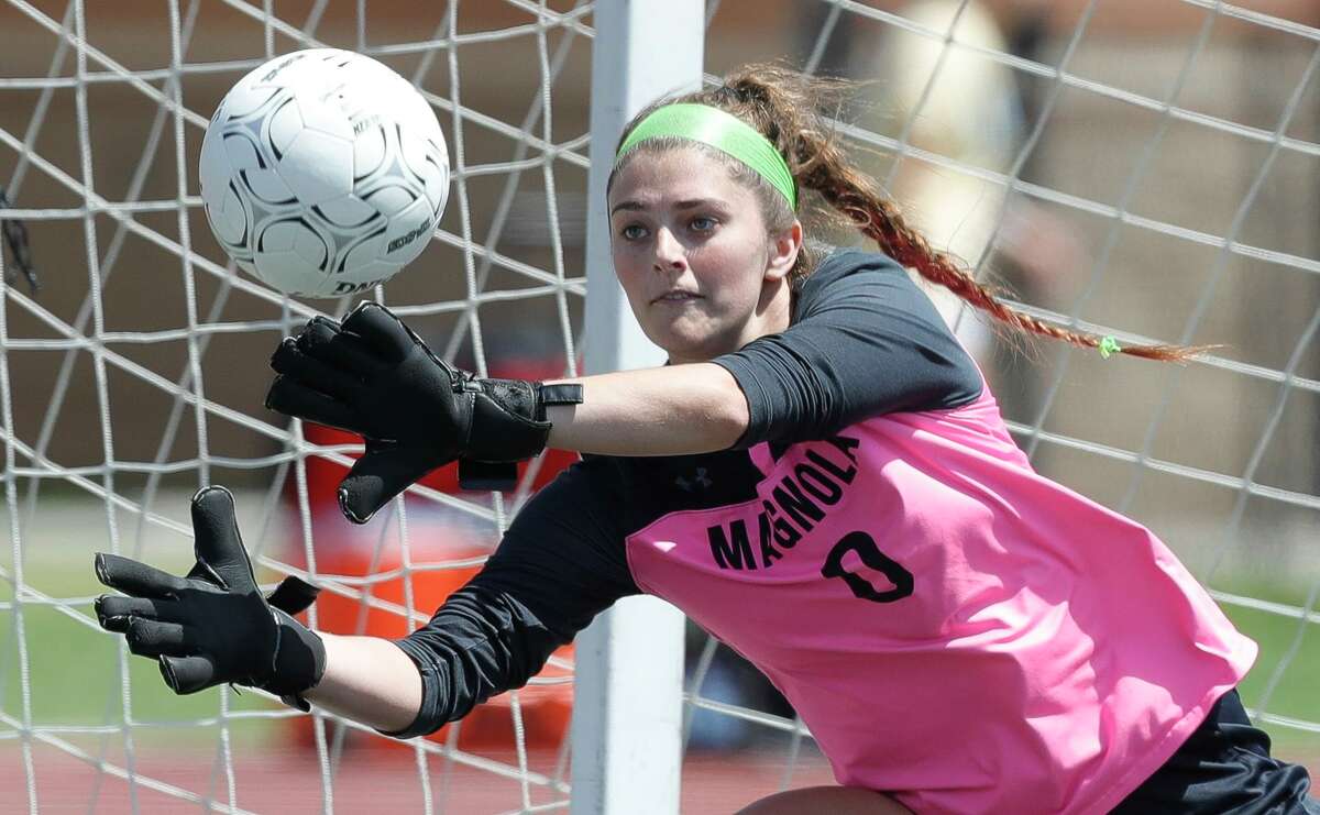 Magnolia goalie Taylor Sanderson (0) makes a stop in the second half of a Region III-5A semifinal high school soccer match at Turner Stadium, Friday, April 8, 2022, in Humble.