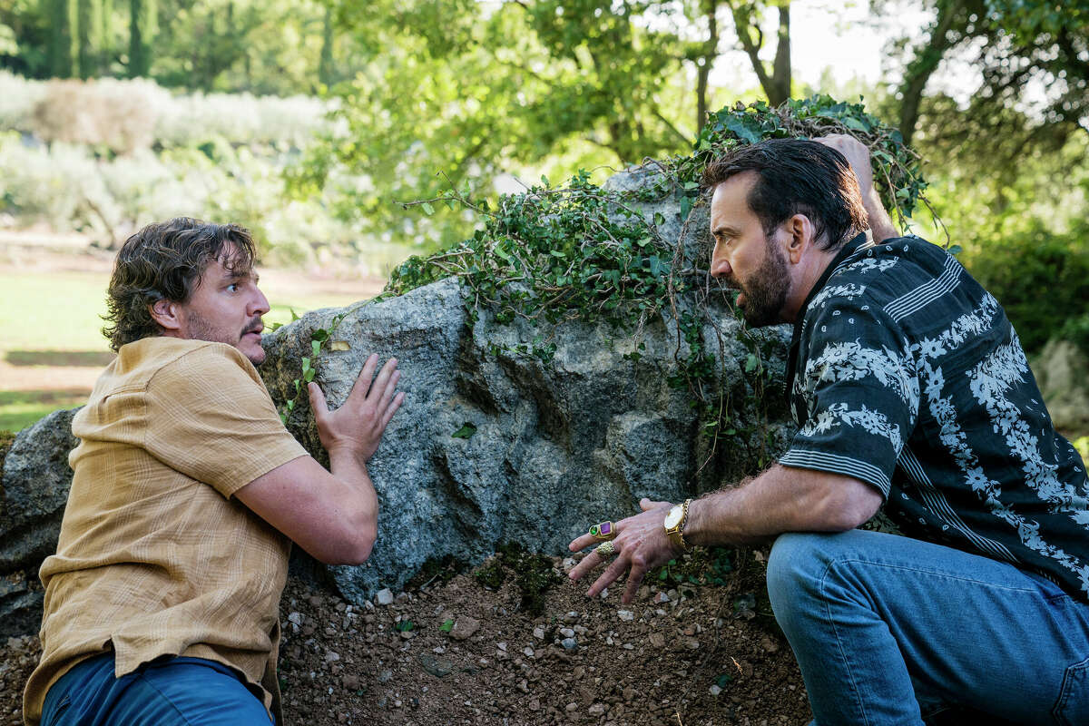 Pedro Pascal as Javi and Nicholas Cage as a fictionalized version of himself in The Unbearable Weight of Massive Talent.