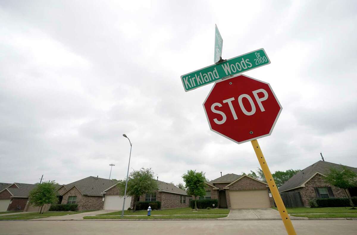 A stop sign leans into the street along Kirkland Woods Drive Tuesday, April 12, 2022, in Houston. Texas Central Railroad, the company planning a 240-mile high-speed train between Houston and Dallas, owes more than $620,000 in unpaid property taxes for various plats they own along the planned route. Of that, more than $216,000 is owed in Harris County, where the company owns numerous homes along or near U.S. 290, including more than two dozen on Kirkland Woods Drive near Texas 6.