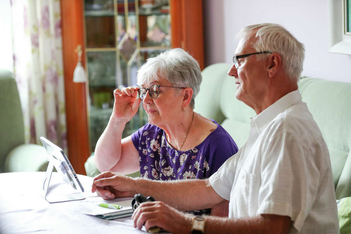 A retired couple use a tablet to access the internet. (Photo by Jan Woitas/picture alliance via Getty Images)