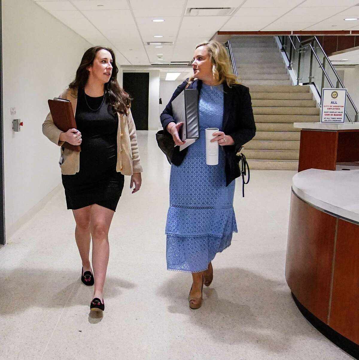 Katie Shelton, left, Chief of Staff for Councilwoman Mary Nan Huffman, right, walk over to chambers at City Hall on Wednesday, April 13, 2022 in Houston. City of Houston employees soon could be eligible for up to three months of paid parental leave under a policy change that passed in City Council on Wednesday. Shelton is a city employee who is pregnant and is due in July.