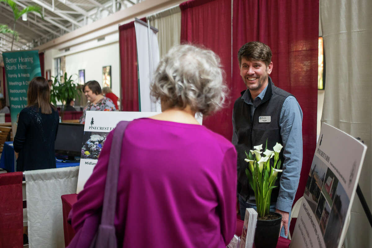 Guests chat with representatives of local organizations at information booths during the Spring Senior Expo Wednesday, April 13, 2022 at the Midland Mall.