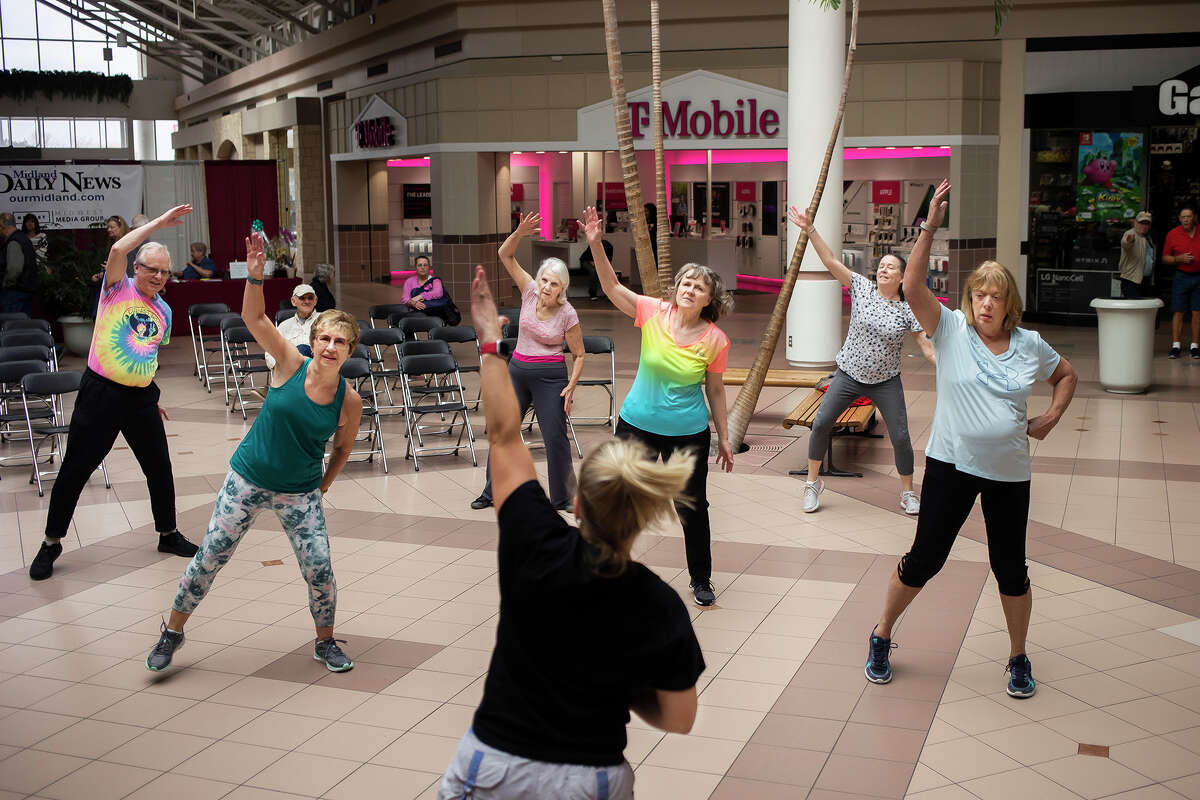 Guests participate in a Zumba class hosted by Trena Winans of Senior Services of Midland County, bottom, during the Spring Senior Expo Wednesday, April 13, 2022 at the Midland Mall.