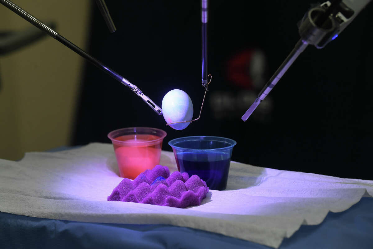 Surgical staff at Christus St. Elizabeth Hospital demonstrate the surgical robots that are becoming a common and preferred method of surgery. In honor of the coming Easter holiday, they dyed eggs using the da Vinci Surgical System. St. Elizabeth was the first hospital in Southeast Texas to procure the technology, performing their first robotic surgery in July of 2013. Photo made Wednesday April 13, 2022. Kim Brent/The Enterprise