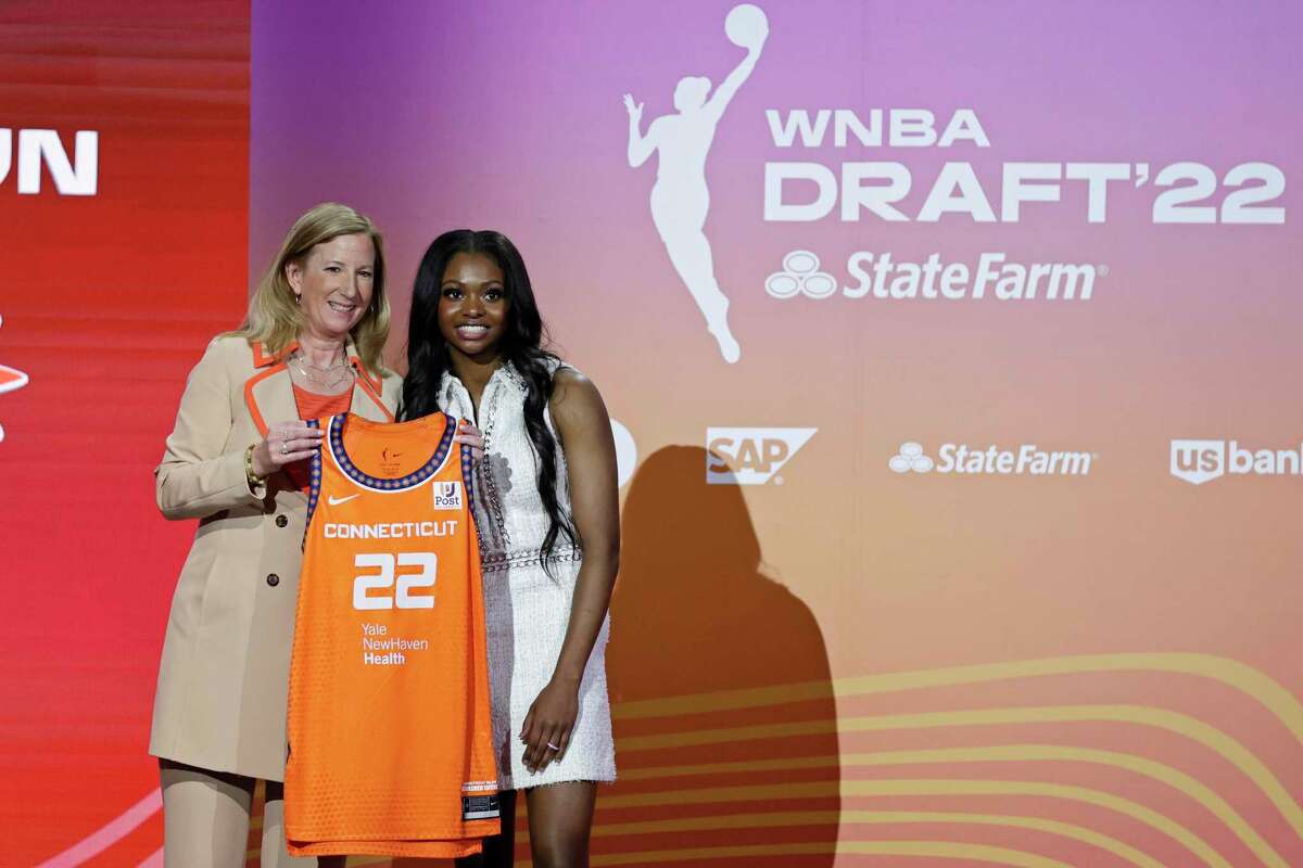 Michigan State’s Nia Clouden, right, poses for a photo with commissioner Cathy Engelbert after being selected by the Connecticut Sun as the 12th overall pick in the WNBA draft on Monday.