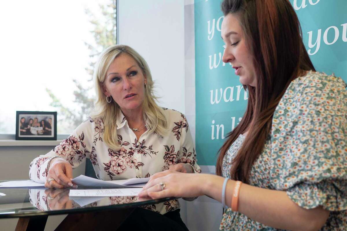 Renee Walrath, left, president and CEO of Walrath Recruiting, and Alexandra Walrath, office administrator, review resumes at their office on Wednesday, April 13, 2022, in Albany, N.Y. (Paul Buckowski/Times Union)