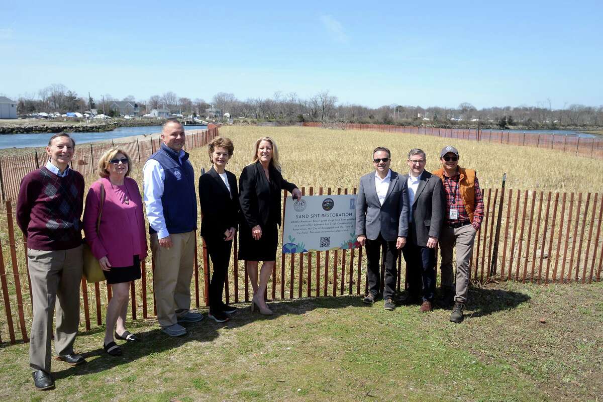 Fairfield First Selectwoman Brenda Kupchick and Bridgeport Mayor Joe Ganim stand with other officials following a news conference next to the sand spit at St. Mary’s by the Sea, in Bridgeport, Conn. April 13, 2022. 42,000 plugs of beach grass have been planted in an effort to stabilize the sand spit along Ash Creek, which is the border between Bridgeport and Fairfield.