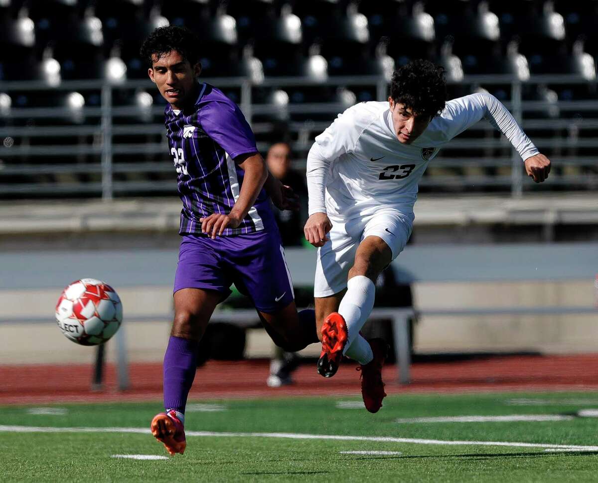 Conroe’s Julian Vega (23) makes a pass against Humble’s Alex Ramirez (22) in the second period of a high school soccer match at Turner Stadium, Thursday, Jan. 13, 2022, in Humble.