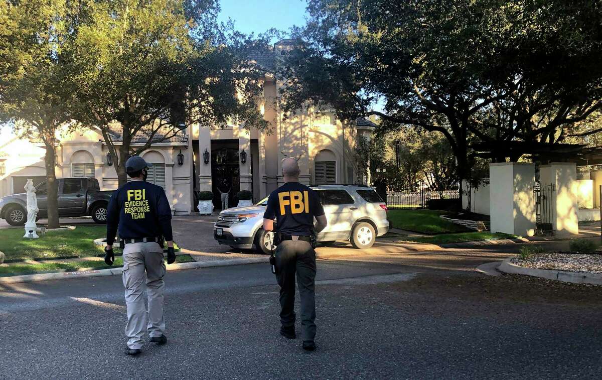 Federal agents search the home of U.S. Rep. Henry Cuellar in Laredo, Texas, on Wednesday, Jan. 19, 2022. (Valarie Gonzalez/The Monitor via AP)