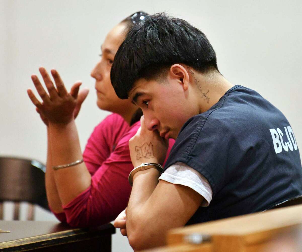 Raul Cervera weeps as he sits with his mother, Rosenda Armendariz, during a hearing in 2019 that certified him as an adult charged with capital murder case. Cervera, now 19, pleaded no contest Tuesday for the shooting death of Abram Garcia IV in 2018.