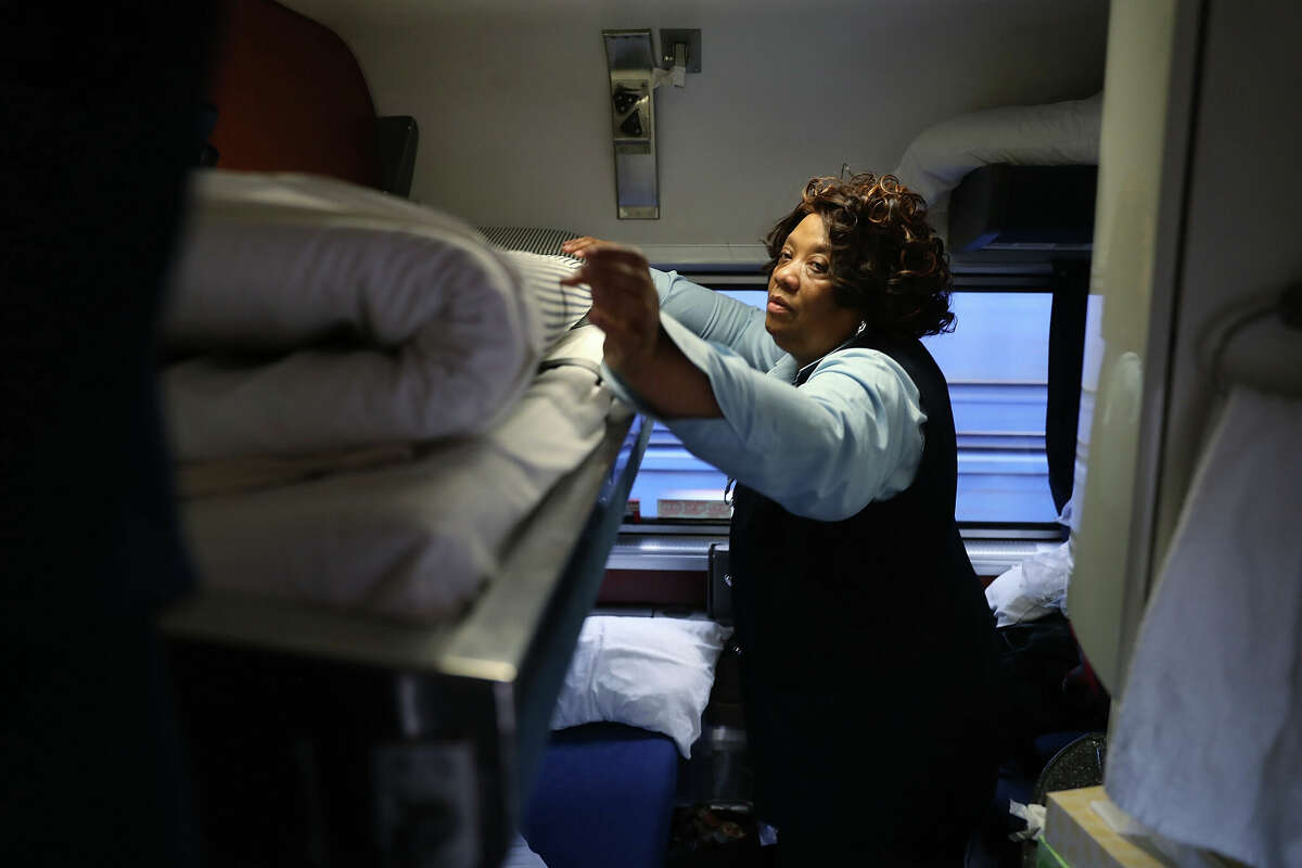 Patricia Johnson makes up a bed in one of the rooms in a sleeper car on Amtrak's California Zephyr.