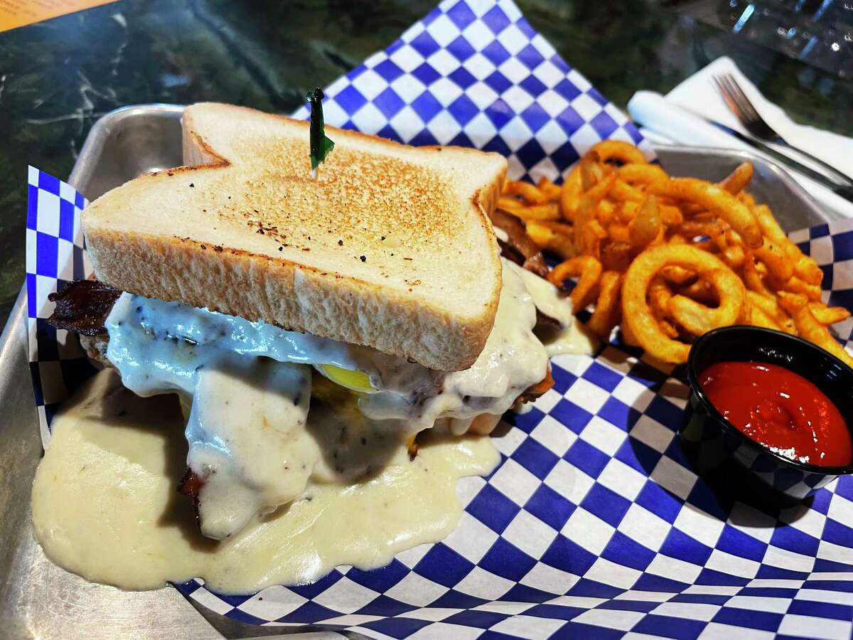 The chicken fried steak sandwich at the Evil Olive in San Antonio with curly fries