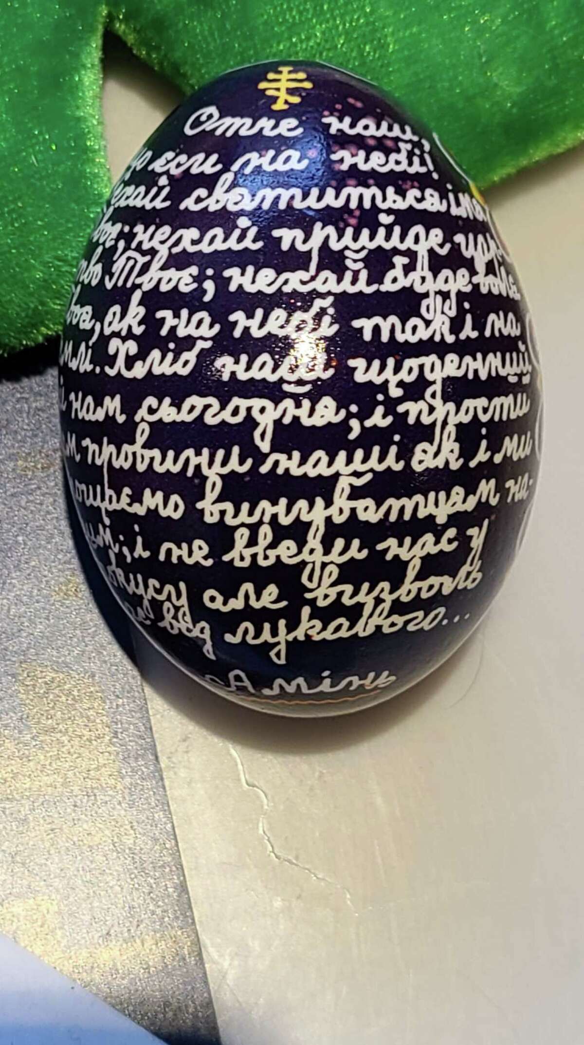 Kim Mathias, of Westport, has her mother’s collection of Ukrainian Easter eggs. This one has the Lord’s Prayer on it.
