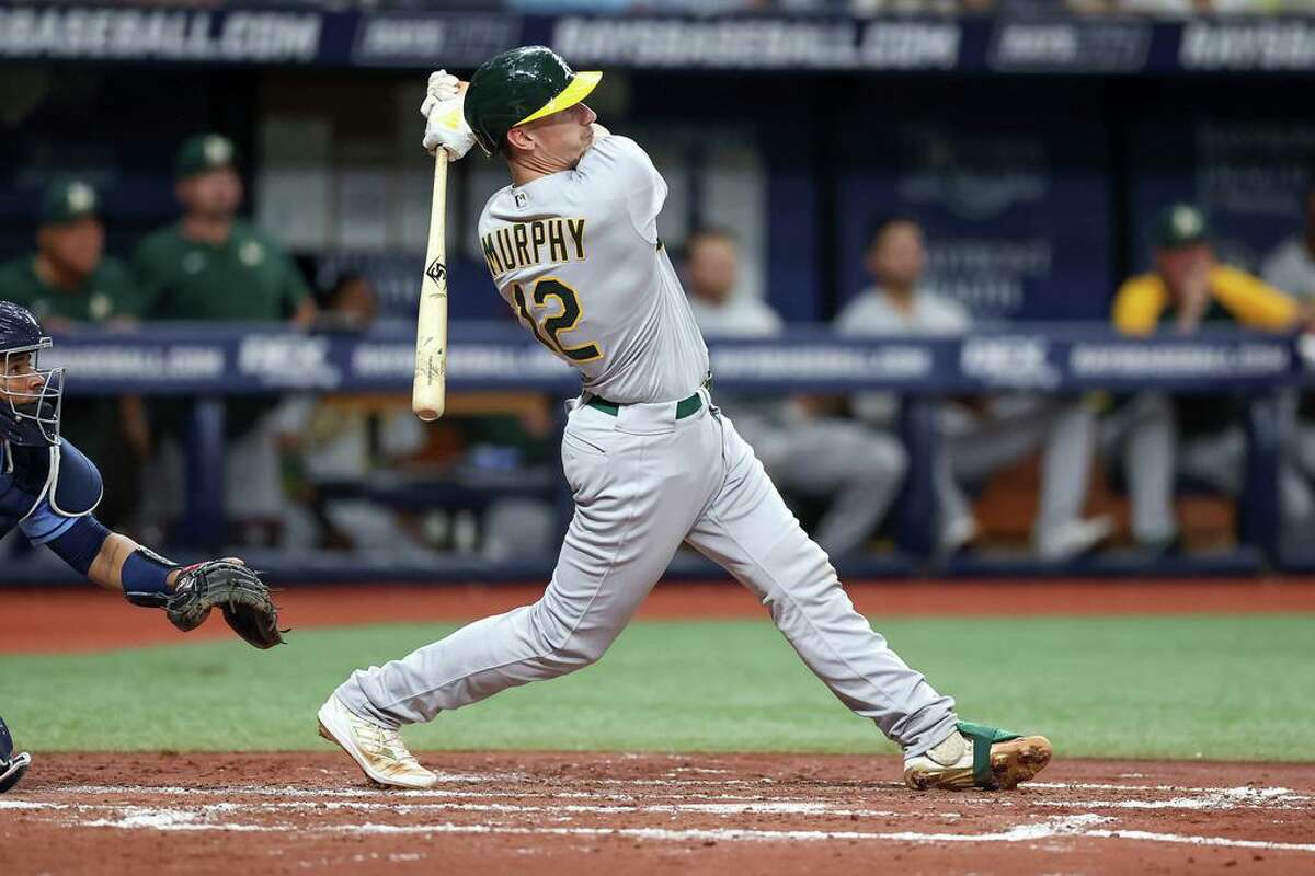 ST. PETERSBURG, FL - APRIL 13: Sean Murphy #12 of the Oakland Athletics follows through on his swing for a three-run home run against the Tampa Bay Rays in the third inning of a baseball game at Tropicana Field on April 13, 2022 in St. Petersburg, Florida. (Photo by Mike Carlson/Getty Images)