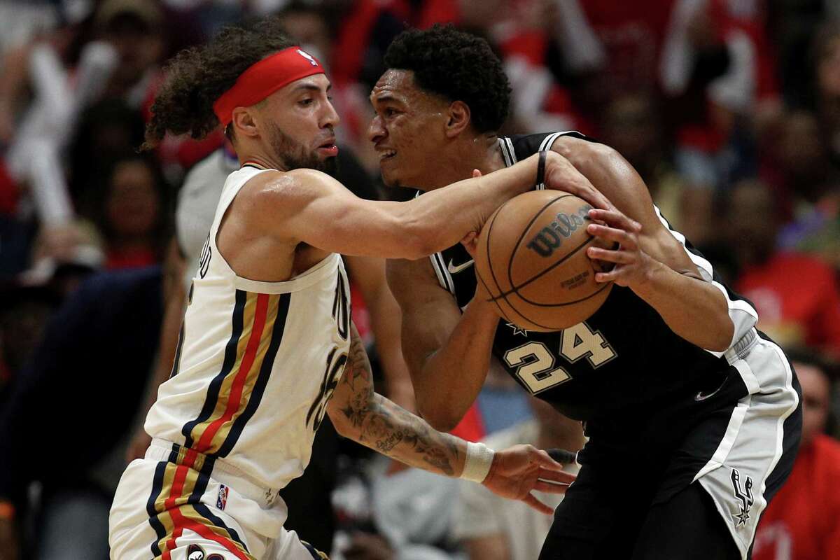 The Pelicans’ Jose Alvarado, left, steals the ball from the Spurs’ Devin Vassell during the second quarter of a play-in game at Smoothie King Center on April 13, 2022, in New Orleans.