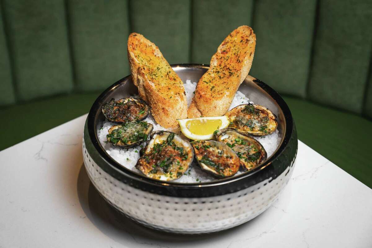 The Warwick, a new upscale restaurant serving American and Southern fare, opens April 15 at 5888 Westheimer. Shown: Charbroiled Gulf oysters topped with a blend of cheeses, seasoned collard greens and garlic butter.