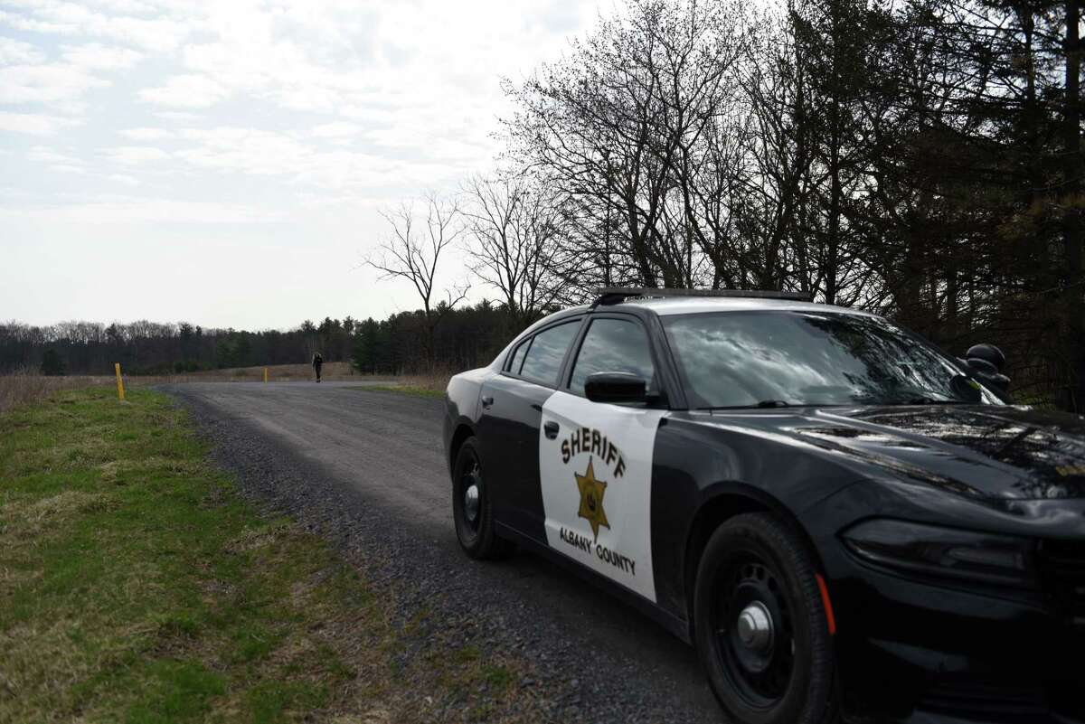 An Albany County Sheriff's vehicle blocks traffic at the end Miller Road where the Sheriff's office is investigating the killing of a man on Wednesday, April 14, 2022, in New Scotland, N.Y. Sheriff Craig Apple described the situation on Miller Road an "isolated incident and the community is safe."