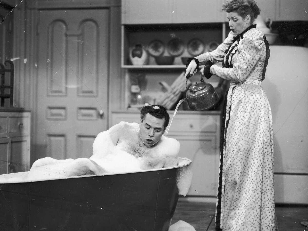 American comedienne and actress Lucille Ball (1911 - 1989) with her co-star and husband Desi Arnaz (1917 - 1986) in a scene from the American television sitcom 'I Love Lucy', circa 1955.