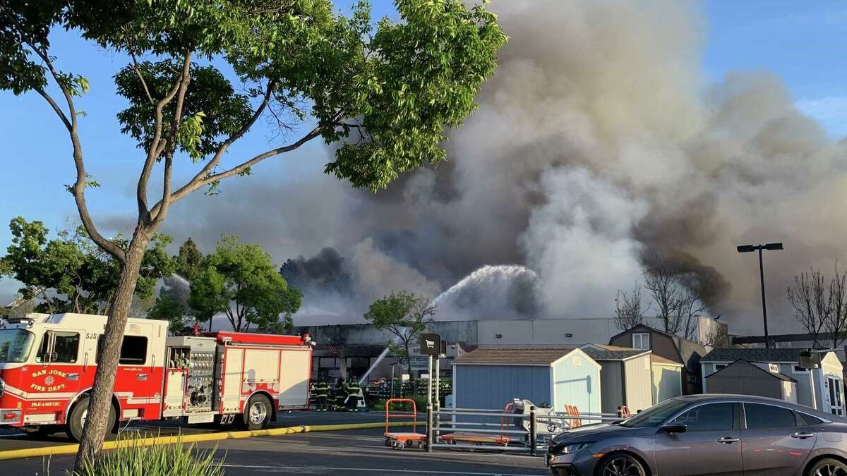 Firefighters battling a blaze that destroyed a Home Depot store in San Jose, Calif. A person suspected of starting the fire was arrested and charged with arson.