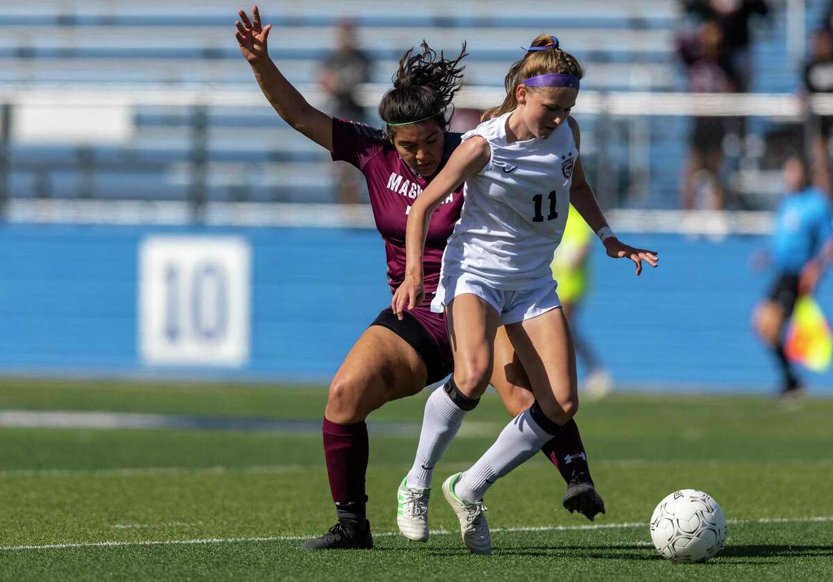 Magnolia midfielder Gabriella Palomino, left, battles for the ball with Frisco Wakeland midfielder Lily Grace Moncrief during a Class 5A girls soccer semifinal in Georgetown, Thursday, Apr., 14, 2022.