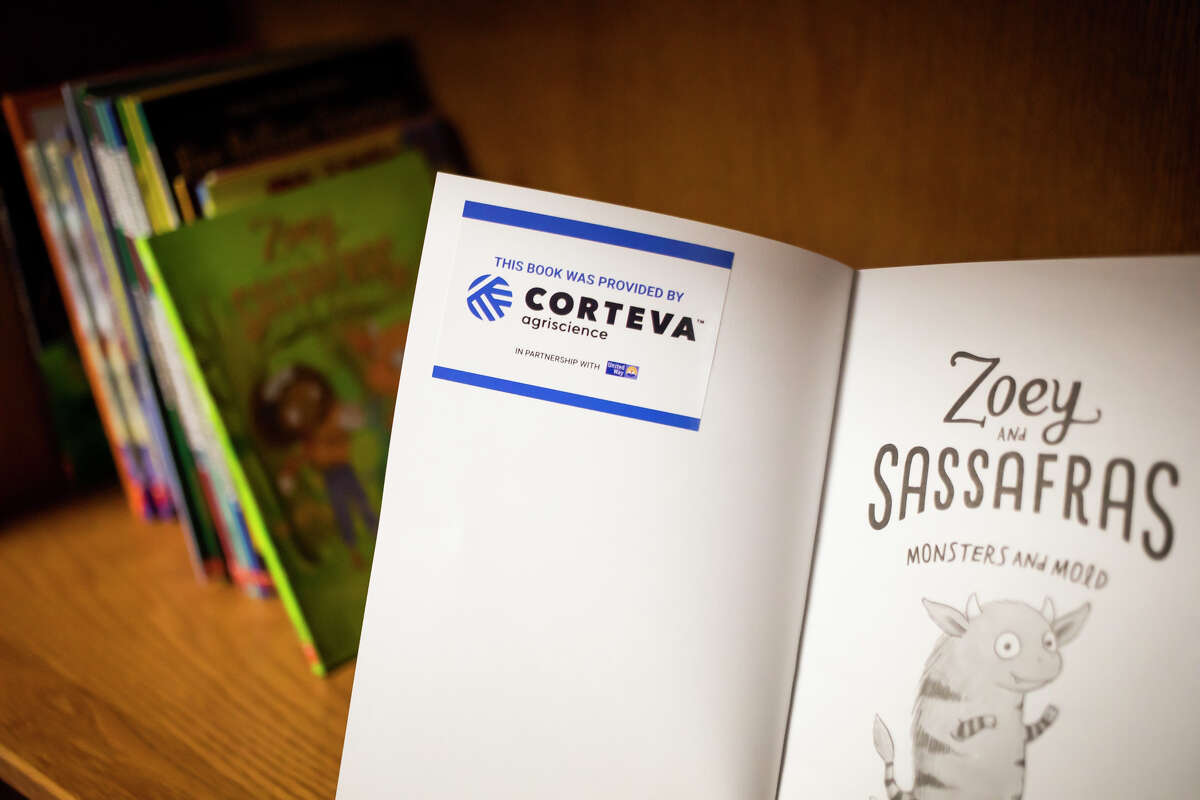 New books purchased by Corteva are arranged in Meridian Elementary School's new library, which was organized by a group of volunteers from Corteva and United Way of Midland County Thursday, April 14, 2022 in Sanford.