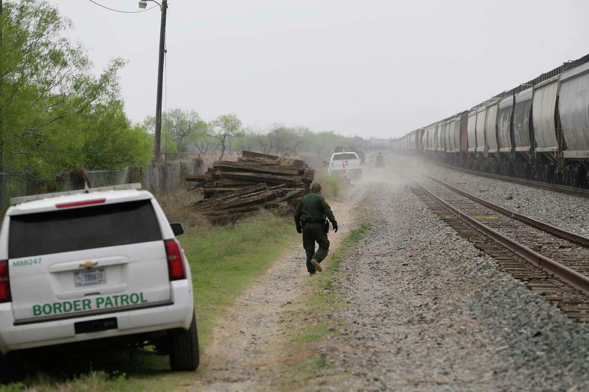 U.S. Border Patrol agents inspect an eastbound train stopped in Hebbronville, Texas, on April 4. Gov. Greg Abbott’s border crackdown is producing a bonanza of no-bid contracts, showering tens of millions of dollars on staffing companies, technology firms and jail builders, including one California-based business that sold Texas hundreds of millions of dollars-worth of unreliable Covid tests before the FDA revoked their authorization last year.