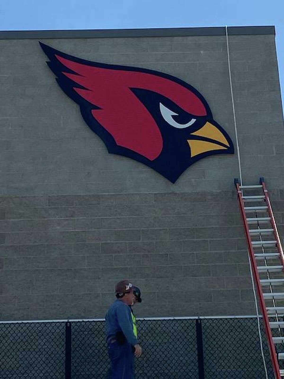The cardinal logo is hung above the bleachers at Greenwich High School's Cardinal Stadium Monday, April 11, 2022.