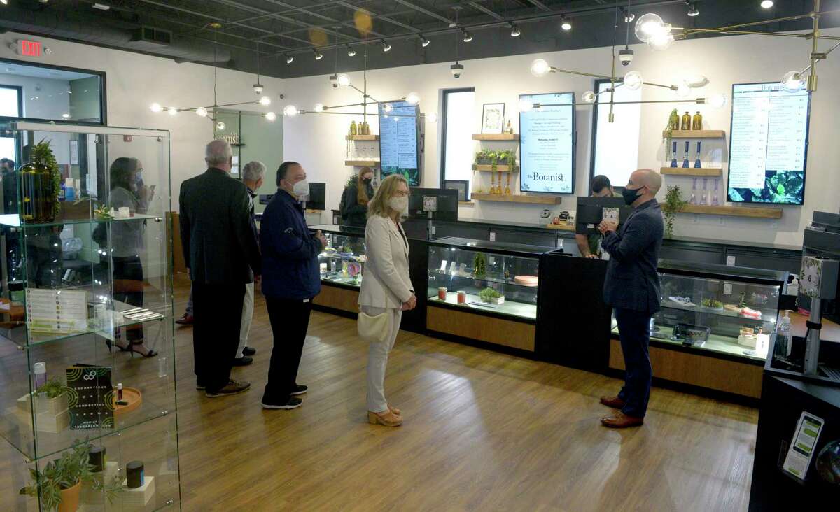 Carl Tirella, right, Acreage Holdings’s general manager in Connecticut, gives a tour during the opening ceremony for The Botanist, the new medical marijuana dispensary on Mill Plain Road, on Oct. 13, 2021 in Danbury, Conn.