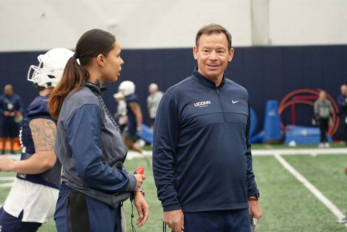 Mickey Grace, offensive analyst for the UConn football program, with head coach Jim Mora.