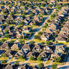 A large group of middle class homes in a suburban Houston, Texas neighborhood shot from an altitude of about 1000 feet.