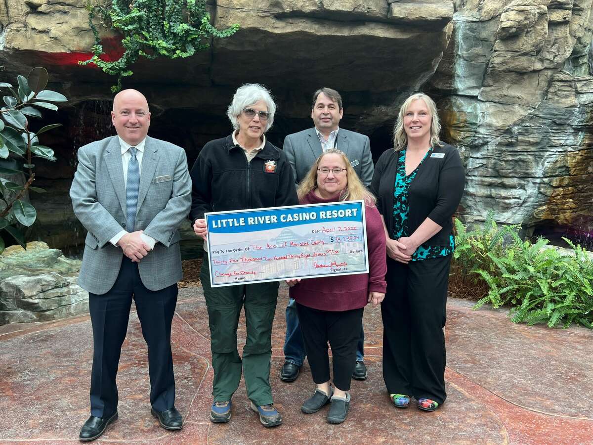 Members of the Arc of Manistee County receive a check for $34,238.04 from the Little River Casino Resort through its Change for Charity program.